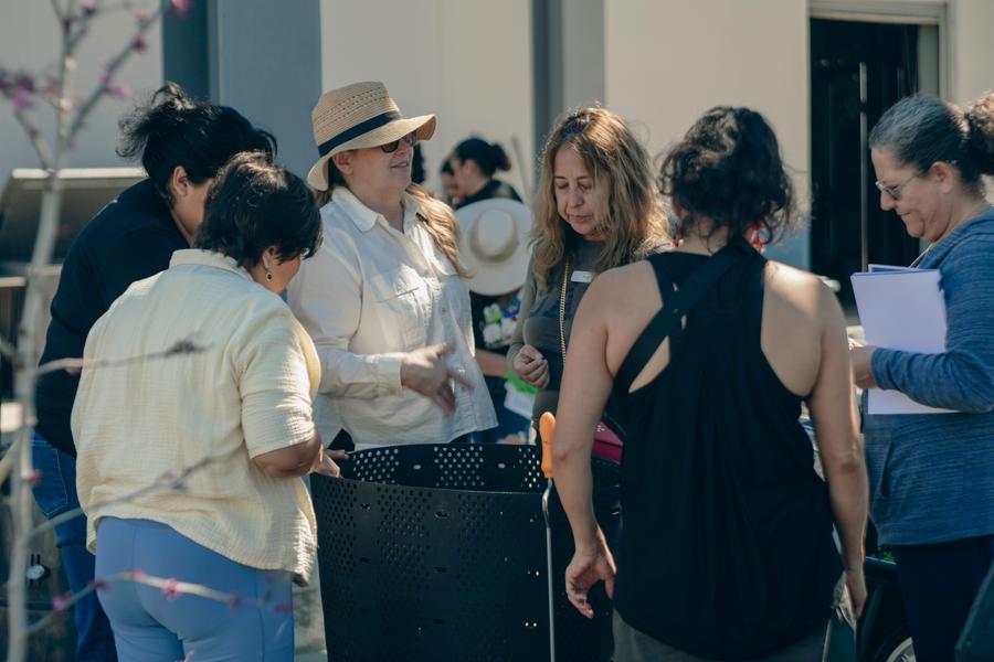Participants pass along flowers and greens for the compost pile.