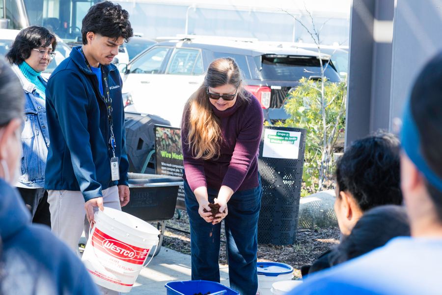 A facilitator explains the composting process to the group.